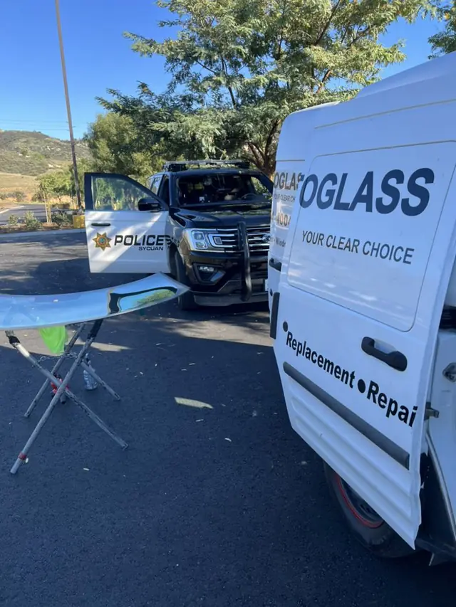 An A1 Auto Glass mobile van servicing a Sycuan Tribal Police vehicle's windshield in the field