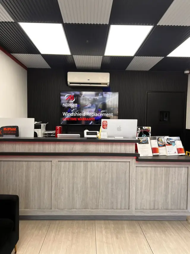 The A1 Auto Glass front desk in El Cajon, with a wall-mounted screen reading Windshield Replacement, Lifetime Warranty