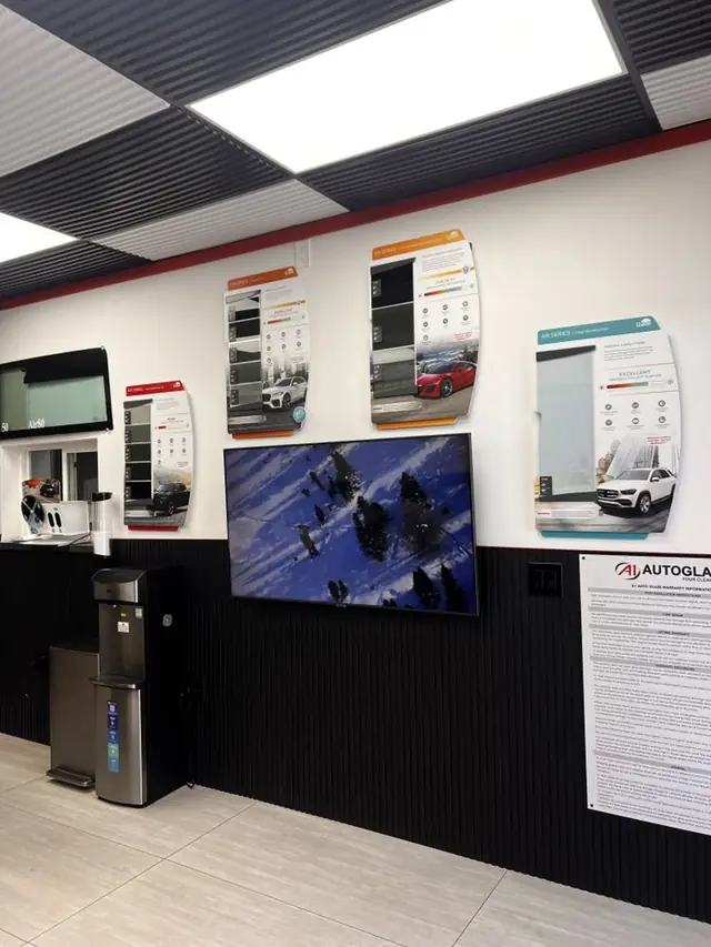 The A1 Auto Glass waiting area in El Cajon with Llumar film sample boards on the wall