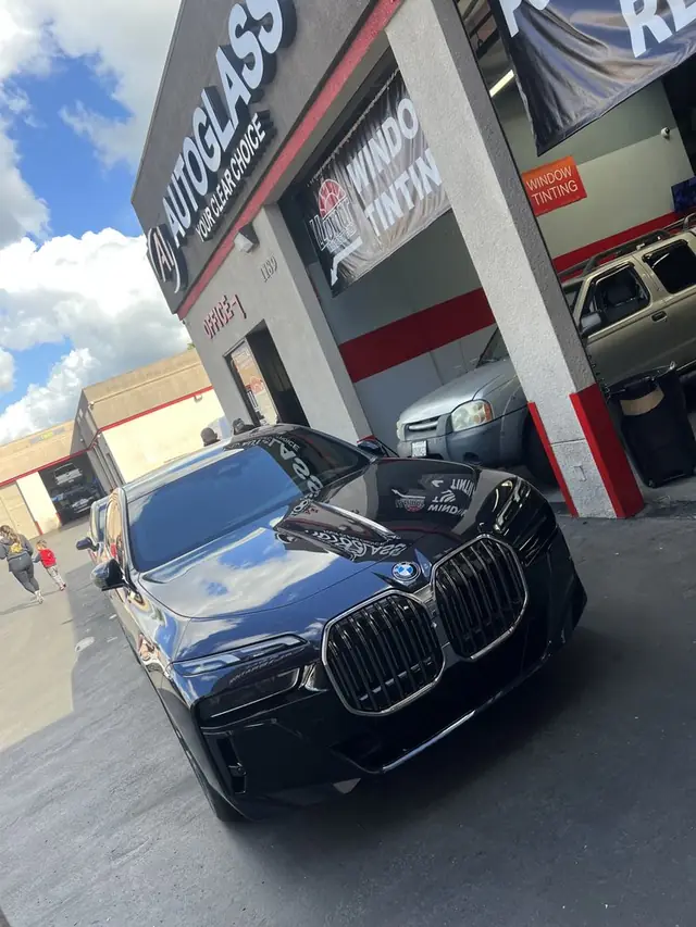 The A1 Auto Glass bay entrance in El Cajon, sign reading A1 Autoglass, Your Clear Choice, with the Llumar tint banner alongside